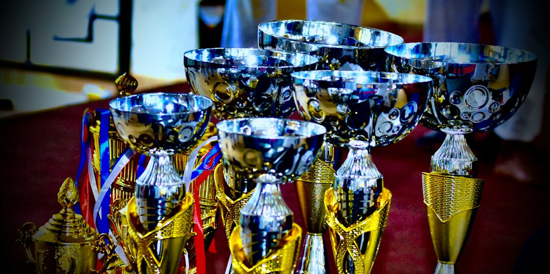 Golden trophy award on a stage with lights